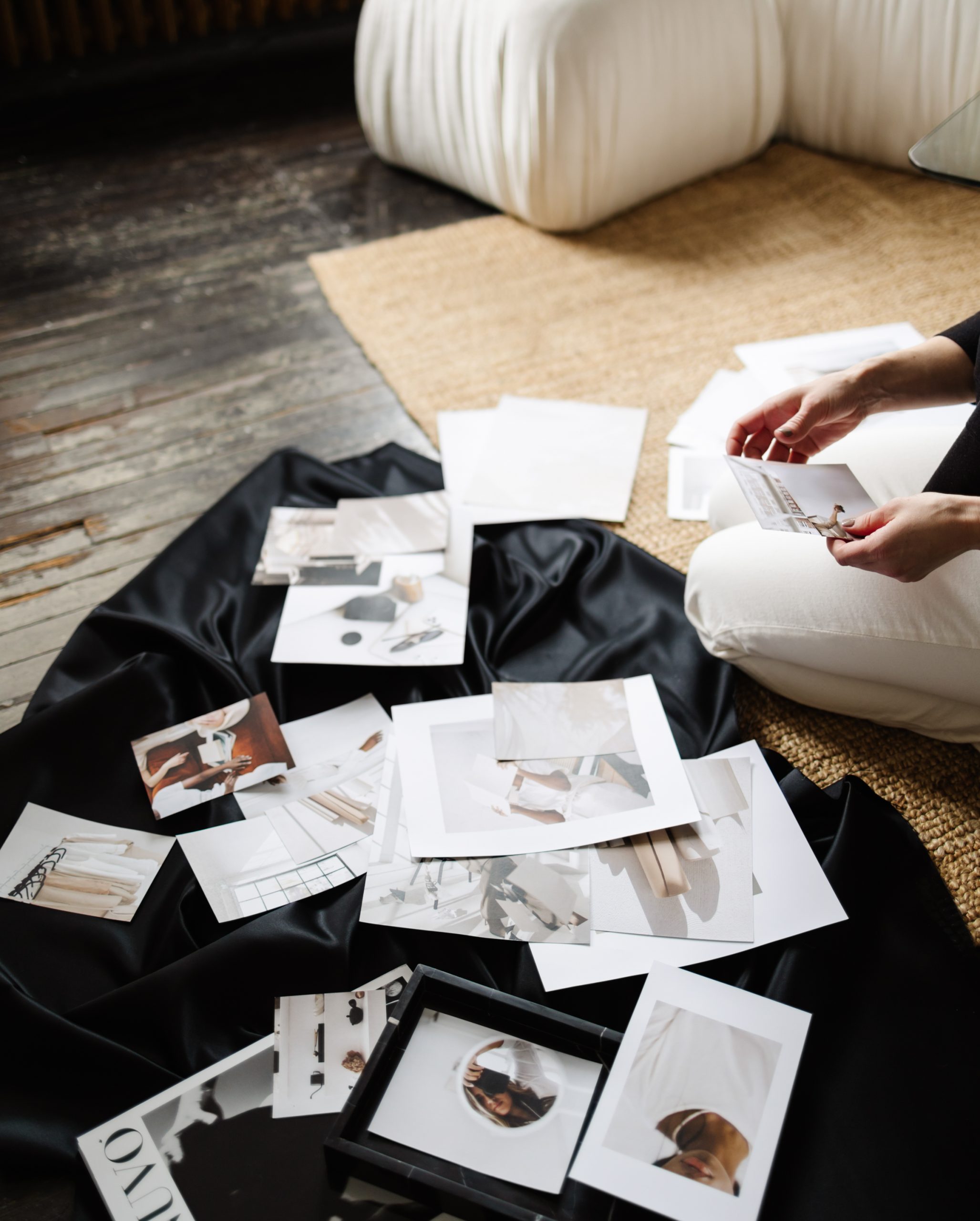 haute stock photography woman sifting through printed images
